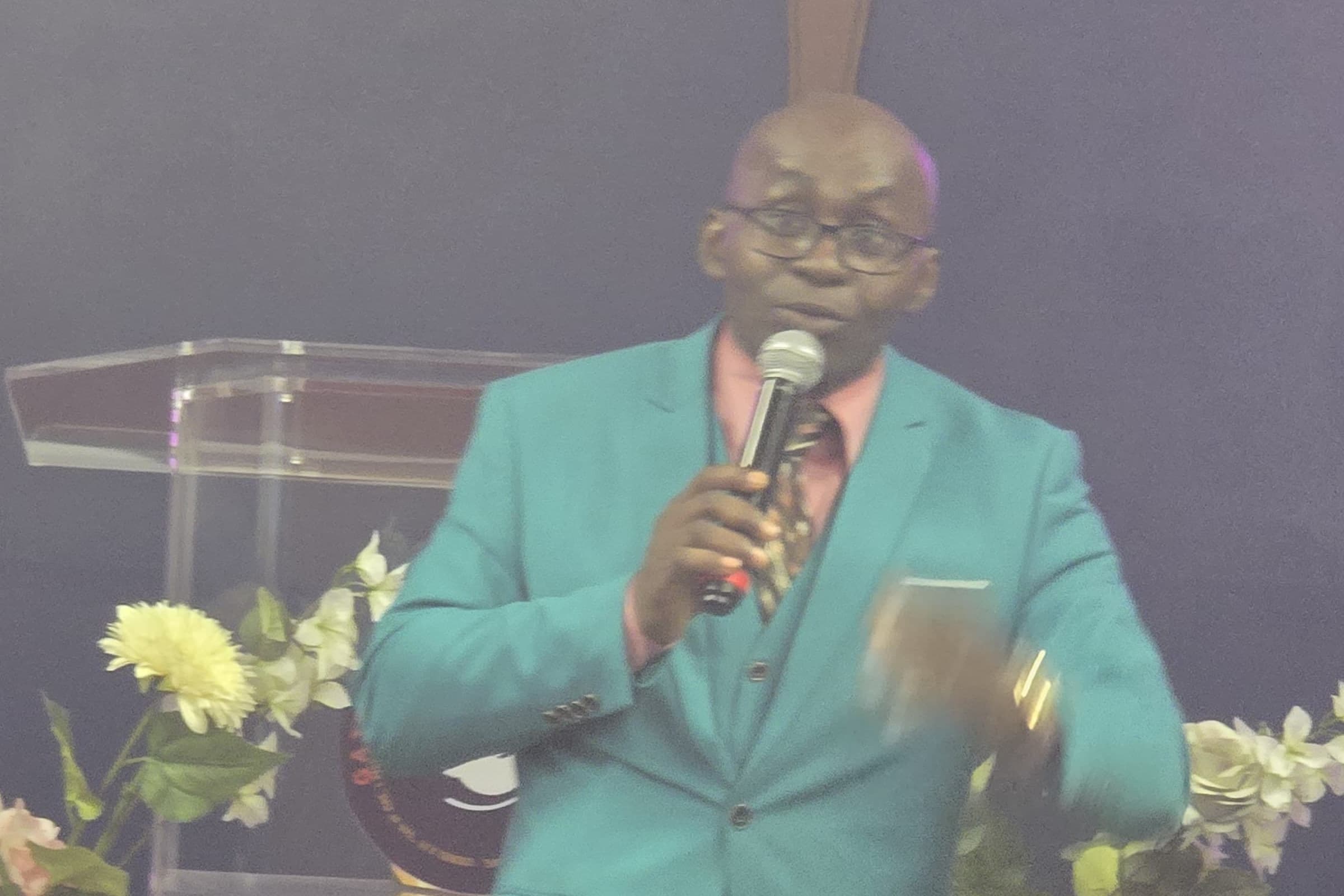 Pastor Reuben Engemise preaching at Gate Watchers Gospel Center